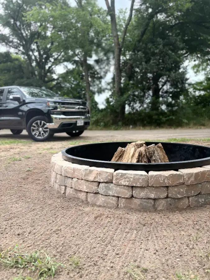 Custom fire pit installed on a gravel pad