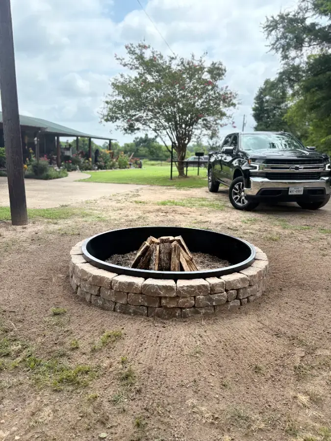 Finished brick fire pit in a backyard