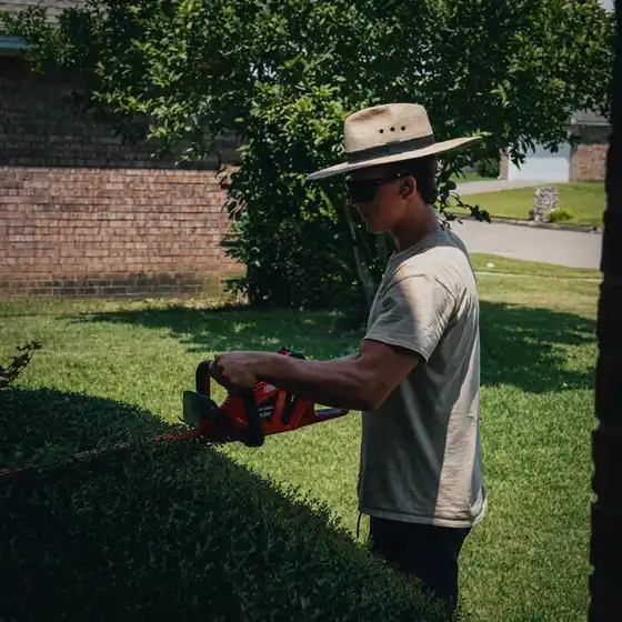 Bassett Bro crew trimming hedges on a job site