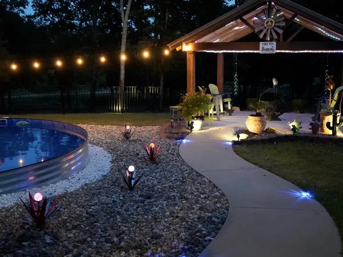 Lit pavilion and pool patio at night